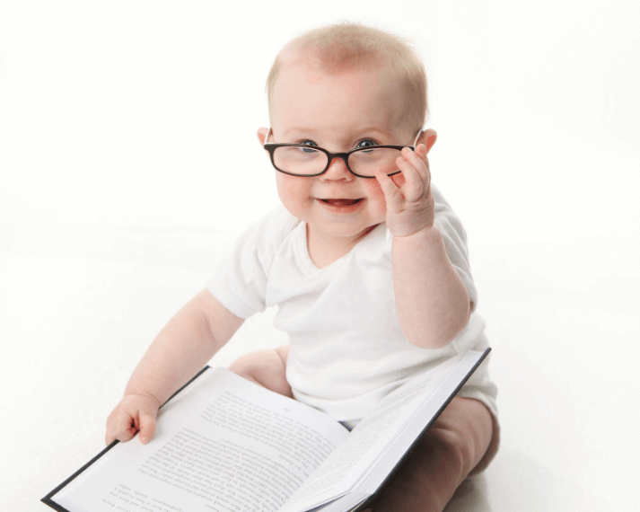 Precocious baby reading an encyclopedia